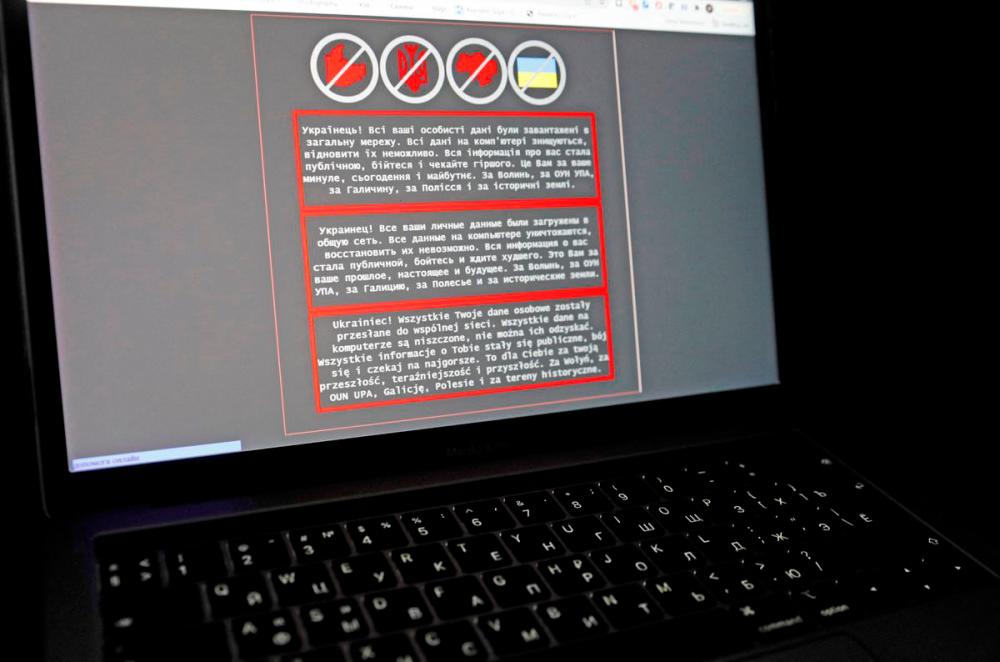 A laptop screen displays a warning message in Ukrainian, Russian and Polish, that appeared on the official website of the Ukrainian Foreign Ministry after a massive cyberattack, in this illustration taken January 14, 2022. REUTERSPix