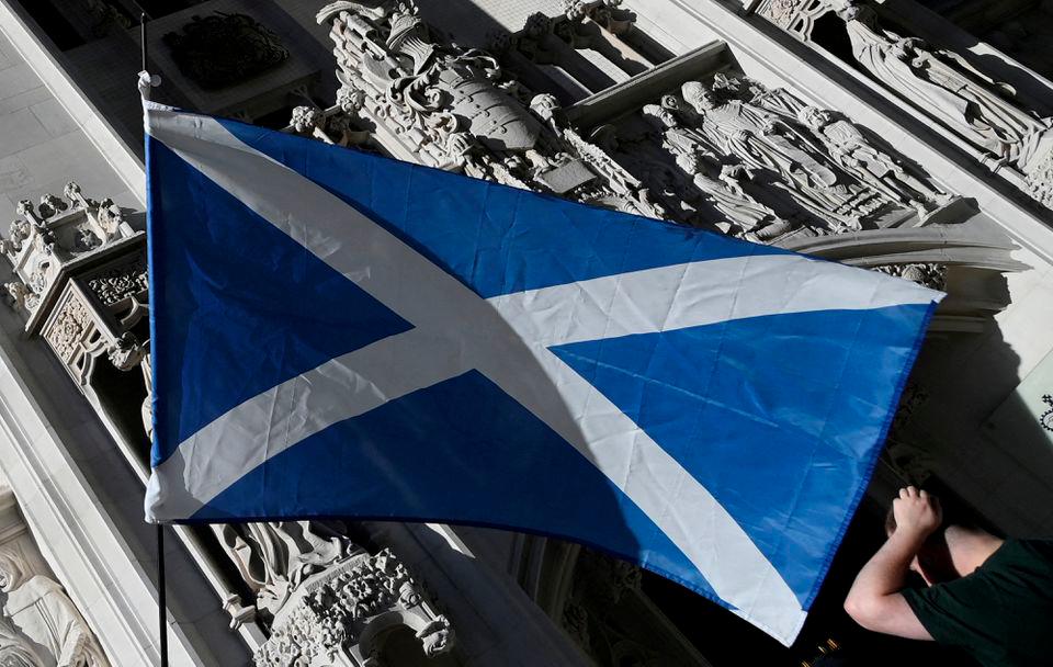 A Scottish Saltire flag is flown as pro-Scottish independence campaigners protest outside of the United Kingdom Supreme Court whilst a case continues to decide whether the Scottish government can hold a second referendum on independence next year without approval from the British parliament, in London, Britain, October 11, 2022. - REUTERSPIX