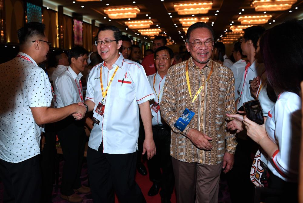 DAP secretary-general Lim Guan Eng with PKR president Datuk Seri Anwar Ibrahim (right) at the opening of the DAP National Conference at the IDCC Convention Centre today. DAP National Chairman Tan Kok Wai is seen behind them. - Bernama