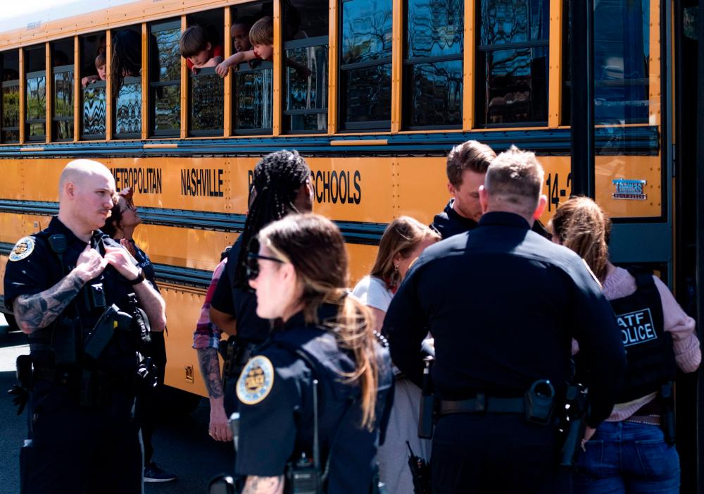 NASHVILLE, TN - MARCH 27: School buses with children arrive at Woodmont Baptist Church to be reunited with their families after a mass shooting at The Covenant School on March 27, 2023 in Nashville, Tennessee. AFPPIX