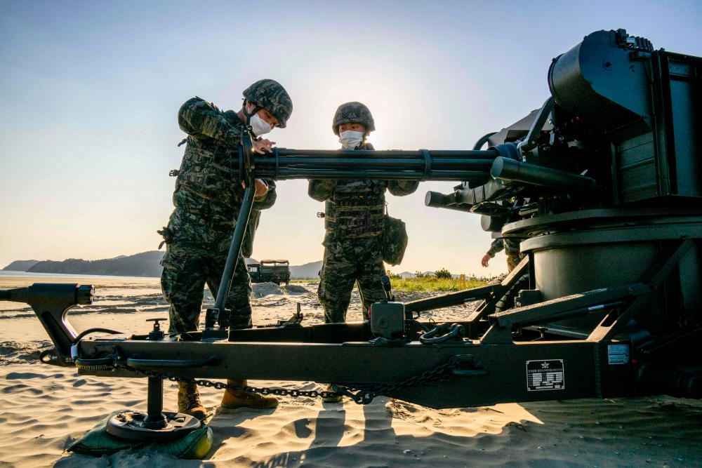 In this picture taken on October 27, 2022, soldiers take part in a routine practice before an upcoming drill on Sagot Beach at Baekryeong Island, located two kilometres from the de facto maritime border and just 14 kilometres from the North Korean mainland. AFPPIX