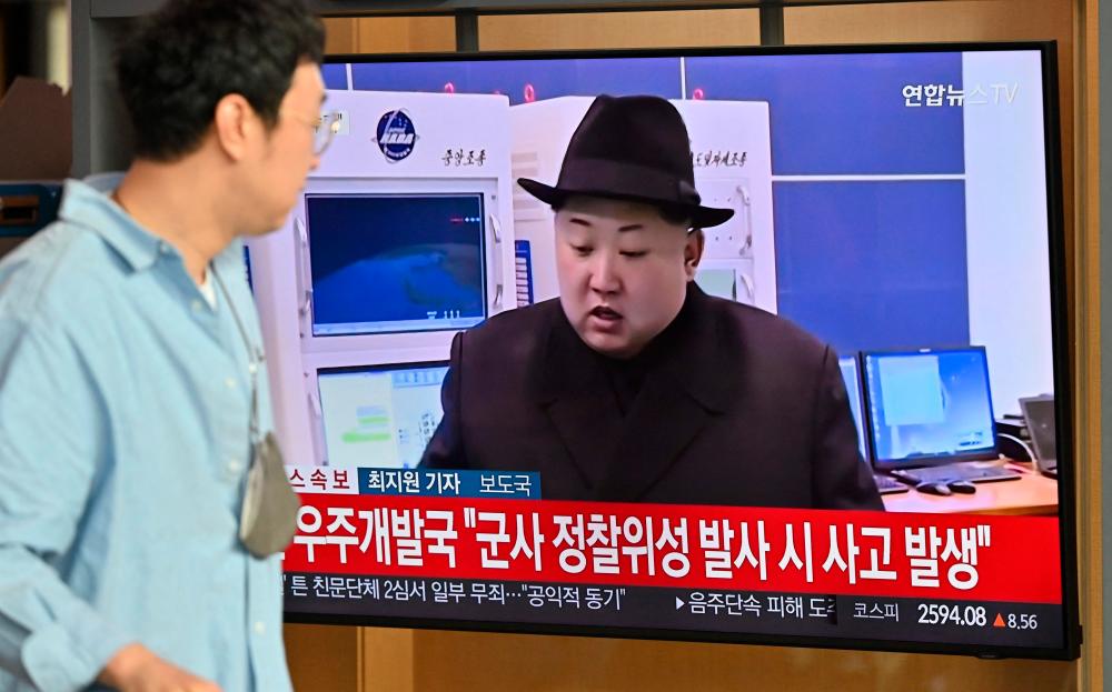A man walks past a television screen showing a news broadcast with file footage of North Korea’s leader Kim Jong Un, at the Seoul Railway Station in Seoul on May 31, 2023/AFPPix