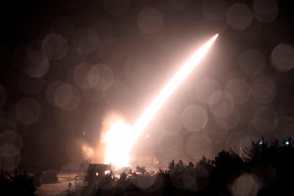 This handout photo taken on October 5, 2022 and released by South Korea's Defence Ministry in Seoul shows the Army Tactical Missile System (ATACMS) firing a missile from an undisclosed location on South Korea's east coast during a South Korea-US joint live-fire exercise aimed to counter North Korea’s missile test. AFPPIX