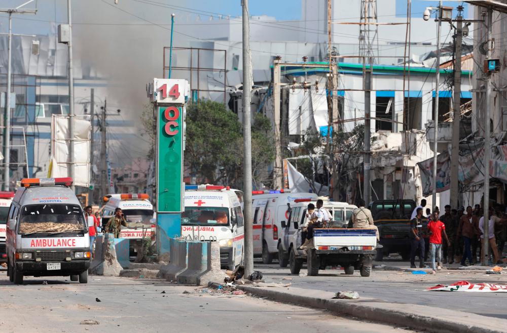 Security personnel and ambulances are stationed near destroyed and damaged buildings after an car bombing targeted the education ministry in Mogadishu on October 29, 2022/AFPPix