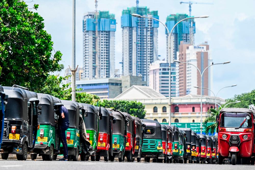 Autorickshaws are parked in a queue along a street to tank up petrol from a fuel station in Colombo, Sri Lanka’s lack of foreign exchange reserves has stalled imports of essentials including fuel, food and medicines. AFPpix