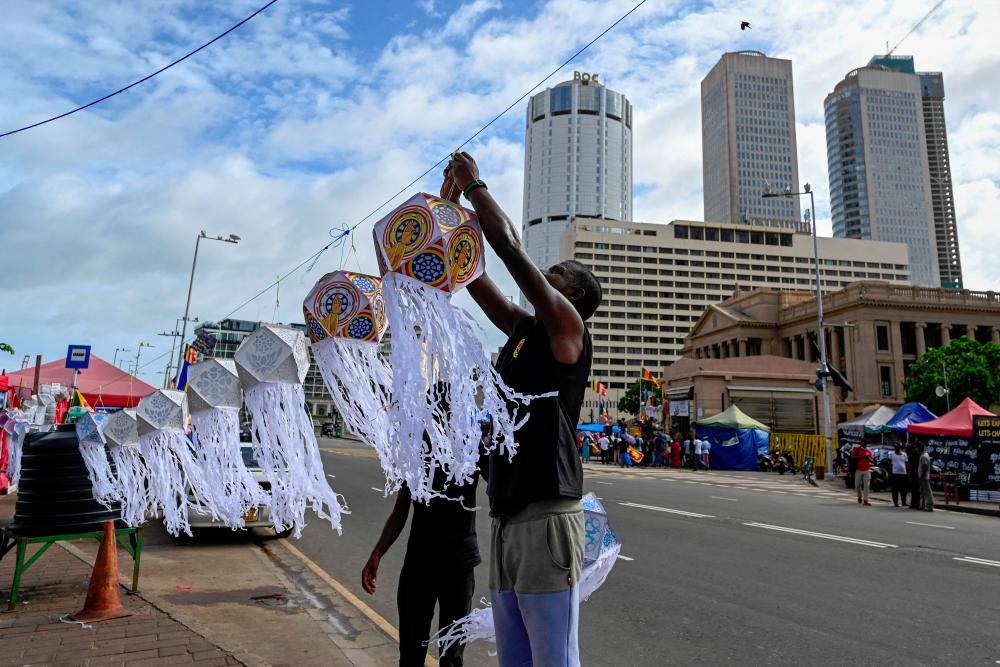Anti-government demonstrators decorate a street near the President’s office during the Vesak festival in Colombo. - AFPpix