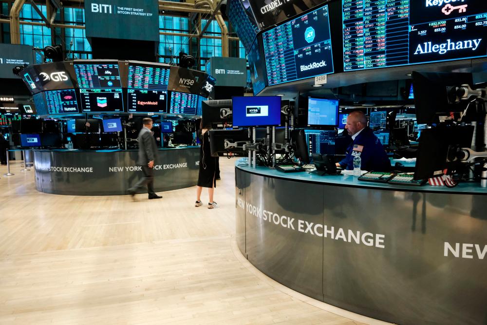Traders woring on the floor of the New York Stock Exchange yesterday morning. – AFPpix