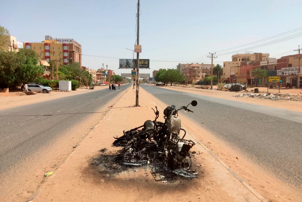 Burnt motorcycles are pictured on a road in southern Khartoum on May 25, 2023. AFPPIX