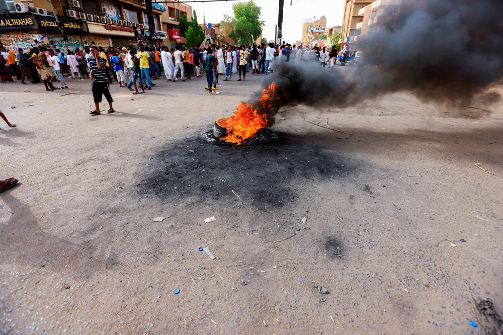 A view of a burning tyre as protesters gather during a rally against military rule, following the last coup and to commemorate the 3rd anniversary of demonstrations in Khartoum North, Sudan July 1, 2022. REUTERSpix