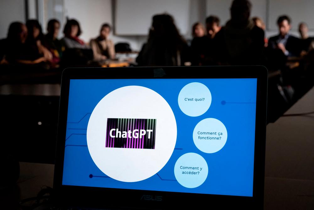 Teachers are seen behind a laptop during a workshop on ChatGpt bot organised for by the School Media Service (SEM) of the Public education of the Swiss canton of Geneva, on February 1, 2023. AFPPIX