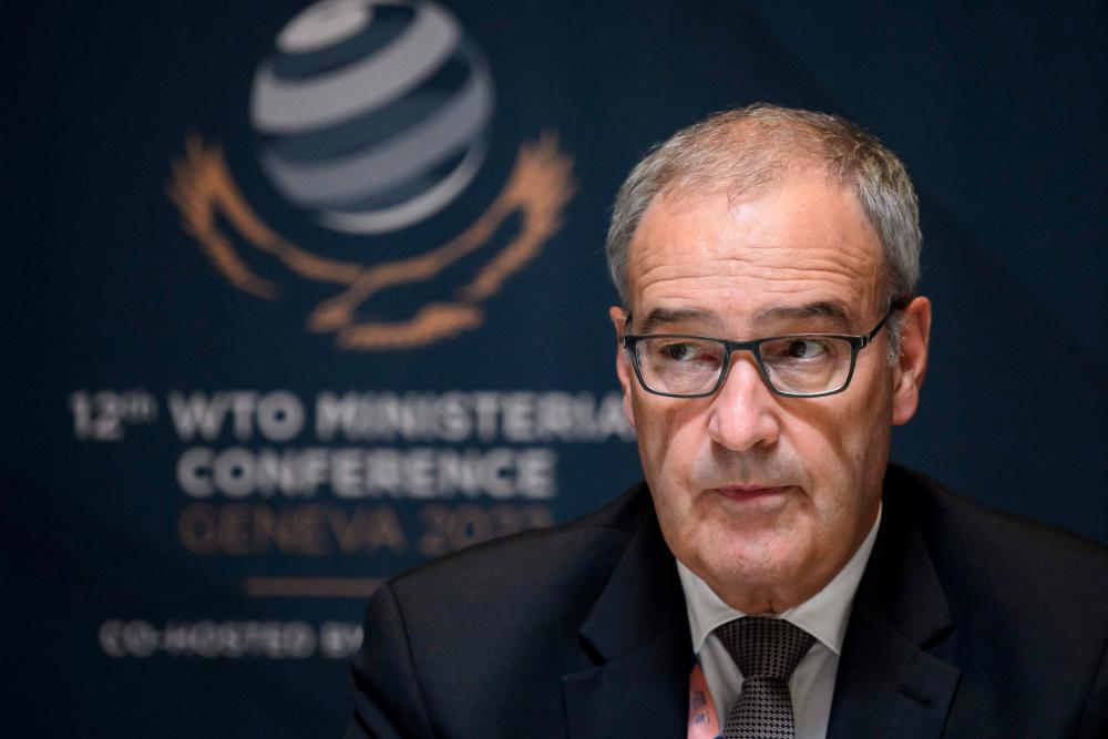 Parmelin looks on during a press conference at the World Trade Organization headquarters during the 12th WTO Ministerial Conference in Geneva yesterday. – AFPpix