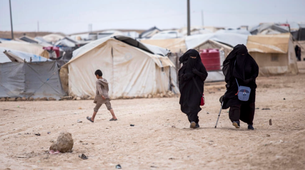 Women walk in the al-Hol camp that houses some 60,000 refugees, including families and supporters of the Islamic State group, many of them foreign nationals, in Hasakeh province, Syria, May 1, 2021. AFPPIX