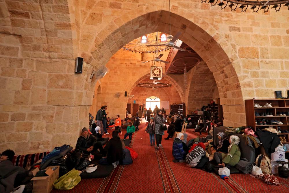 Displaced Syrians take refuge at the Sultan Ibrahim Mosque in the regime-controlled town of Jableh, northwest of the capital Damascus, on February 12, 2023 following a deadly earthquake in Turkey and Syria. AFPPIX
