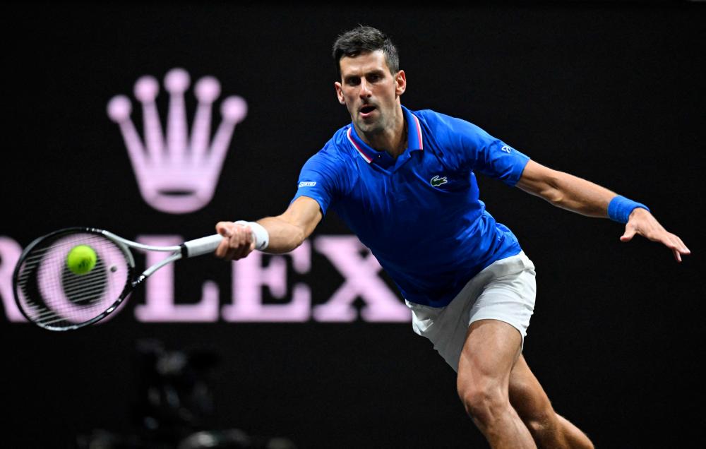 Serbia's Novak Djokovic of Team Europe returns the ball to USA's Frances Tiafoe of Team World during their 2022 Laver Cup men's singles tennis match at the O2 Arena in London on September 24, 2022. - AFPPIX