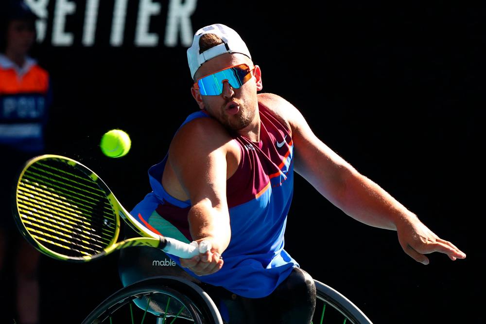 Australia’s Dylan Alcott hits a return against Netherlands’ Sam Schroder during their men’s quad wheelchair singles final match on day eleven of the Australian Open tennis tournament in Melbourne on January 27, 2022. AFPPIX