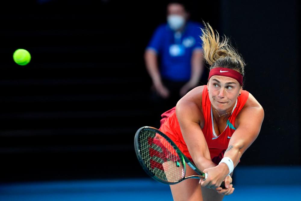 Belarus’ Aryna Sabalenka hits a return against Australia’s Storm Sanders during their women’s singles match on day two of the Australian Open tennis tournament in Melbourne on January 18, 2022. AFPPIX