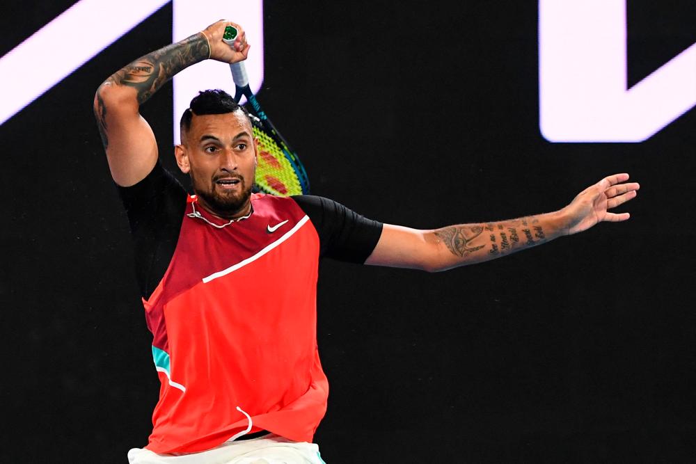 Australia’s Nick Kyrgios hits a return against Britain’s Liam Broady during their men’s singles match on day two of the Australian Open tennis tournament in Melbourne on January 18, 2022. AFPPIX