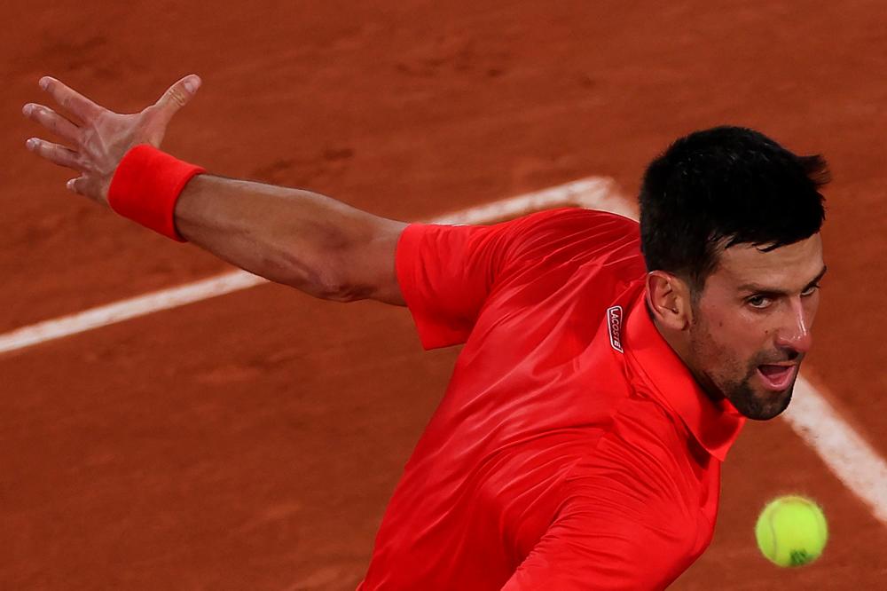 Serbia’s Novak Djokovic returns the ball to Japan’s Yoshihito Nishioka during their men’s singles match on day two of the Roland-Garros Open tennis tournament at the Court Philippe-Chatrier in Paris on May 23, 2022. AFPPIX