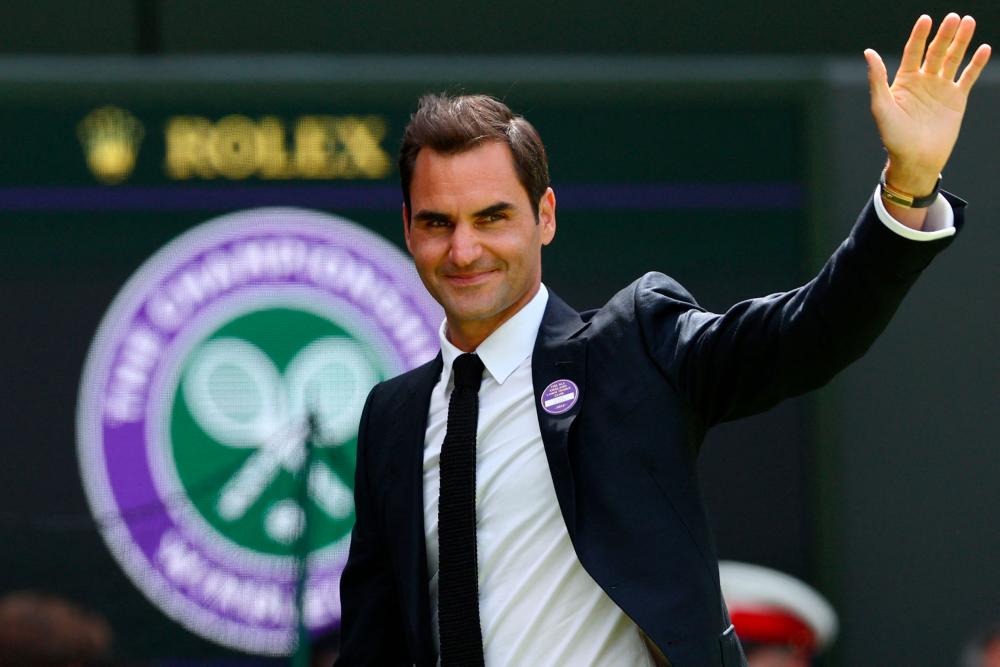 Swiss former tennis player Roger Federer waves during the Centre Court Centenary Ceremony, on the seventh day of the 2022 Wimbledon Championships at The All England Tennis Club in Wimbledon, southwest London, on July 3, 2022. AFPPIX