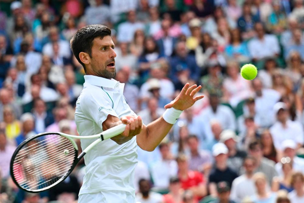 Serbia’s Novak Djokovic returns the ball to Australia’s Thanasi Kokkinakis during their men’s singles tennis match on the third day of the 2022 Wimbledon Championships at The All England Tennis Club in Wimbledon, southwest London, on June 29, 2022. AFPPIX