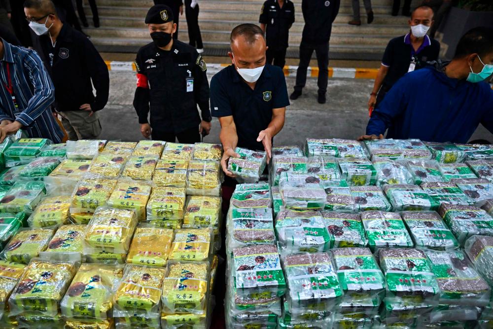 Thai policemen display packages of crystal methamphetamine before a press conference at the Narcotics Suppression Bureau in Bangkok on January 24, 2023. AFPPIX