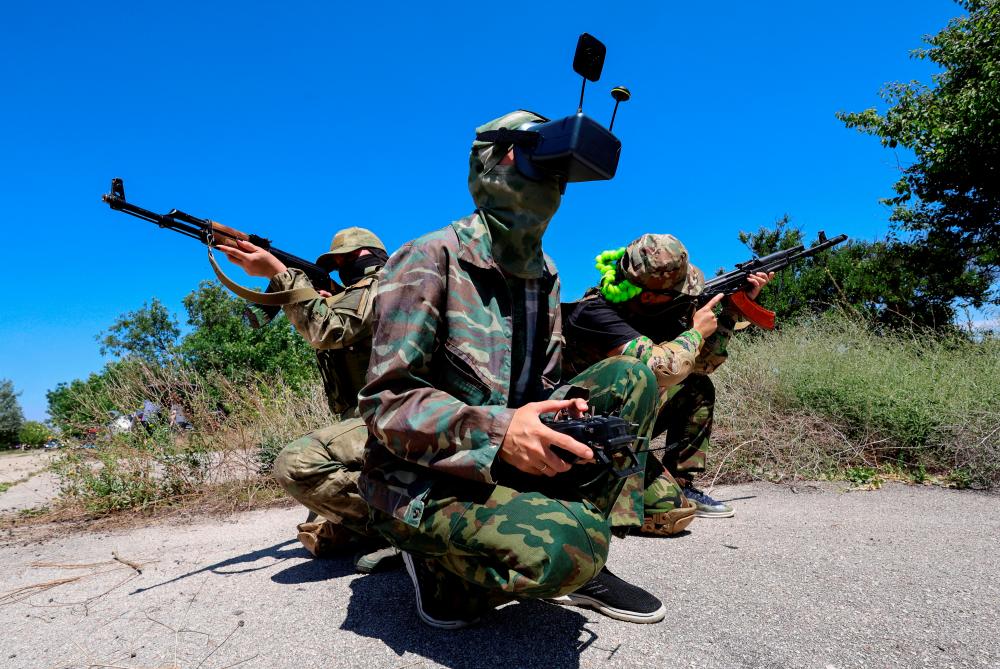 Service members of a Russian territorial defence female unit operate FPV drones and practise battle tactics while training at a firing ground near Yevpatoriya, Crimea, July 22, 2023. REUTERSPIX