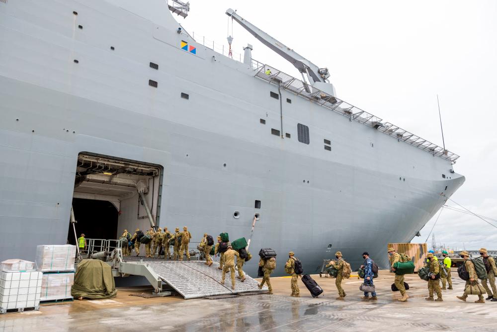 Members of the Australian Defence Force embark on HMAS Adelaide at the Port of Brisbane before departure to Tonga, in Brisbane, Australia, January 20, 2022. Australian Department Of Defence/Handout via REUTERSpix
