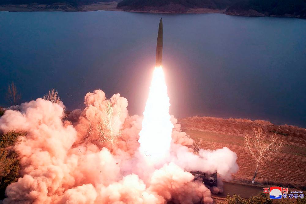 TOPSHOT - This picture taken on March 14, 2023 and released by North Korea's official Korean Central News Agency (KCNA) on March 15 shows a missile being launched by a unit of the Korean People's Army, in charge of operational missions on the Western Front, at an undisclosed location in North Korea. AFPPIX