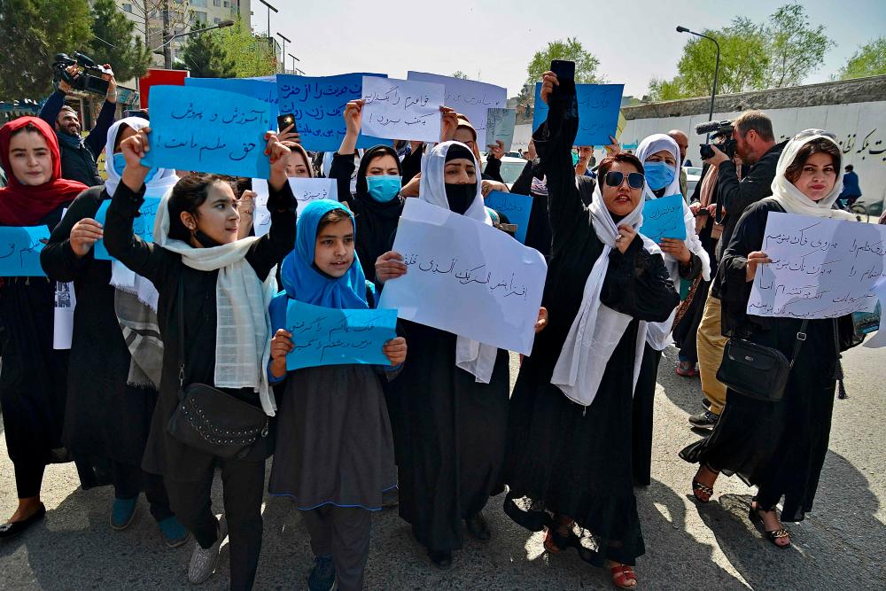 Afghan women and girls take part in a protest in front of the Ministry of Education in Kabul on March 26, 2022, demanding that high schools be reopened for girls. AFPPIX