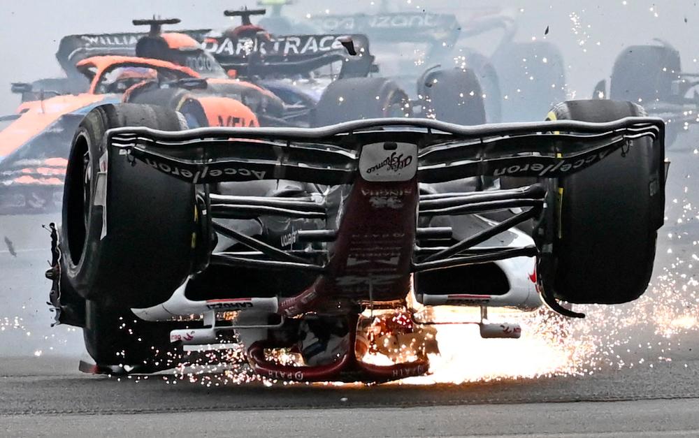 Alfa Romeo Chinese driver Zhou Guanyu skids across the track after a collision with Mercedes’ British driver George Russell (unseen) during the Formula One British Grand Prix at the Silverstone motor racing circuit in Silverstone, central England on July 3, 2022. AFPPIX