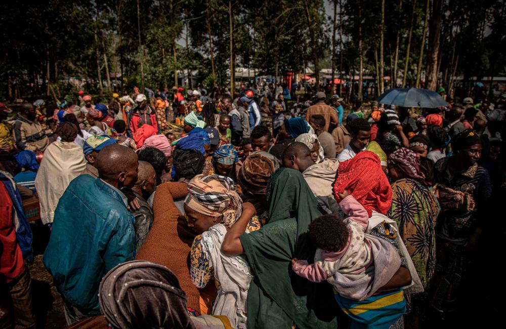 Internal displaced paople, fleeing the recent clashes between M23 rebels and Congolese soldiers, gather in Kanyarushinya north of Goma on May 27, 2022. AFPPIX