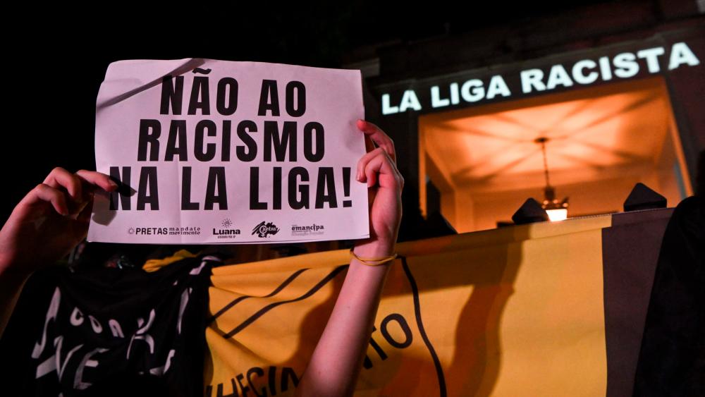 A demonstrator holds a sign reading “No to racism in La Liga” during a protest against racism and in support of Vinicius Junior who was the target of persistent racist abuse. AFPPIX