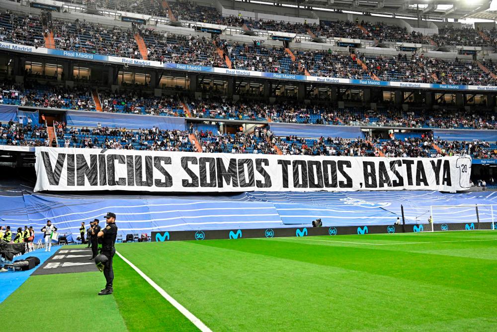 A picture taken prior the Spanish league football match between Real Madrid CF and Rayo Vallecano de Madrid shows a banner reading ‘We all are Vinicius. Enough (of racism)’ referring to Real Madrid’s Brazilian forward Vinicius Junior at the Santiago Bernabeu stadium in Madrid on May 24, 2023. AFPPIX