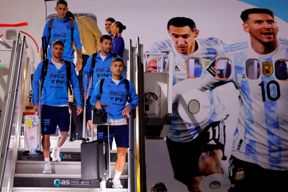 Argentina’s forward Lionel Messi (2nd right) and teammates arrive at the Hamad International Airport in Doha on Nov 17. – AFPPIX