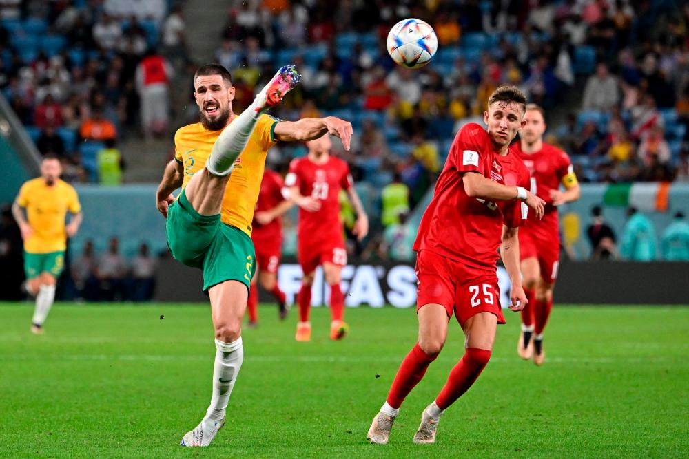 Australia’s defender #02 Milos Degenek fights for the ball with Denmark’s midfielder #25 Jesper Lindstrom during the Qatar 2022 World Cup Group D football match between Australia and Denmark at the Al-Janoub Stadium in Al-Wakrah, south of Doha on November 30, 2022. AFPPIX