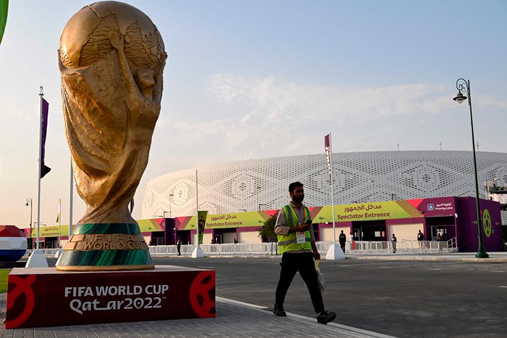 A man walks outside the Al-Thumama Stadium in Doha on November 8, 2022, ahead of the Qatar 2022 FIFA World Cup football tournament. AFPPIX