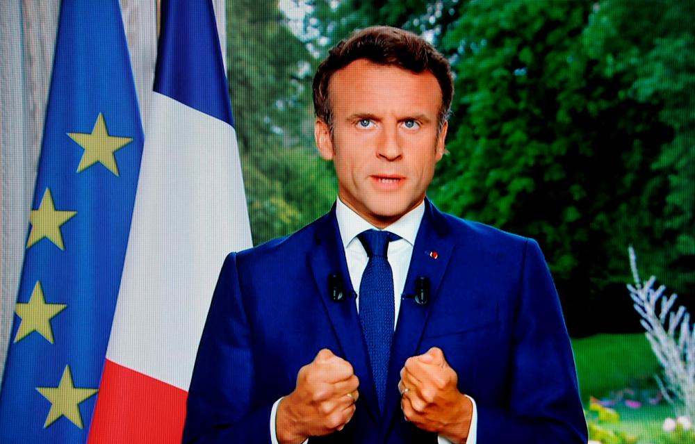 A photo of a TV screen shows French President Emmanuel Macron speaking during televised address on June 22, 2022, in Paris. AFPPIX
