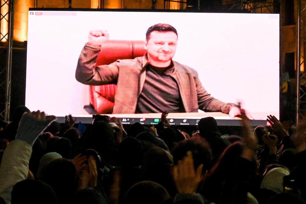Demonstrators watch an address of Ukrainian President Volodymyr Zelensky on the big screen during a rally in support of Ukraine in Tbilisi on March 4, 2022. AFPPIX