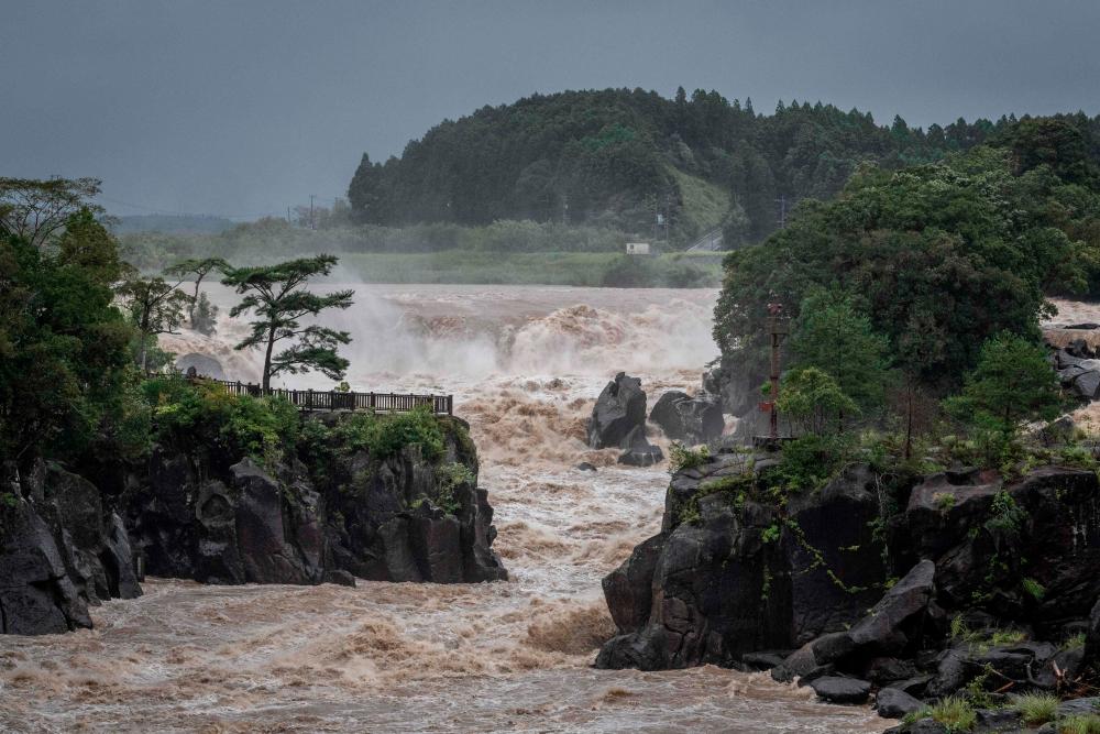 Raging waters flow along the Sendai River in the wake of Typhoon Nanmadol in Isa, Kagoshima prefecture on September 19, 2022. Typhoon Nanmadol made landfall in southwestern Japan late on September 18, as authorities urged millions of people to take shelter from the powerful storm’s high winds and torrential rain. AFPPIX