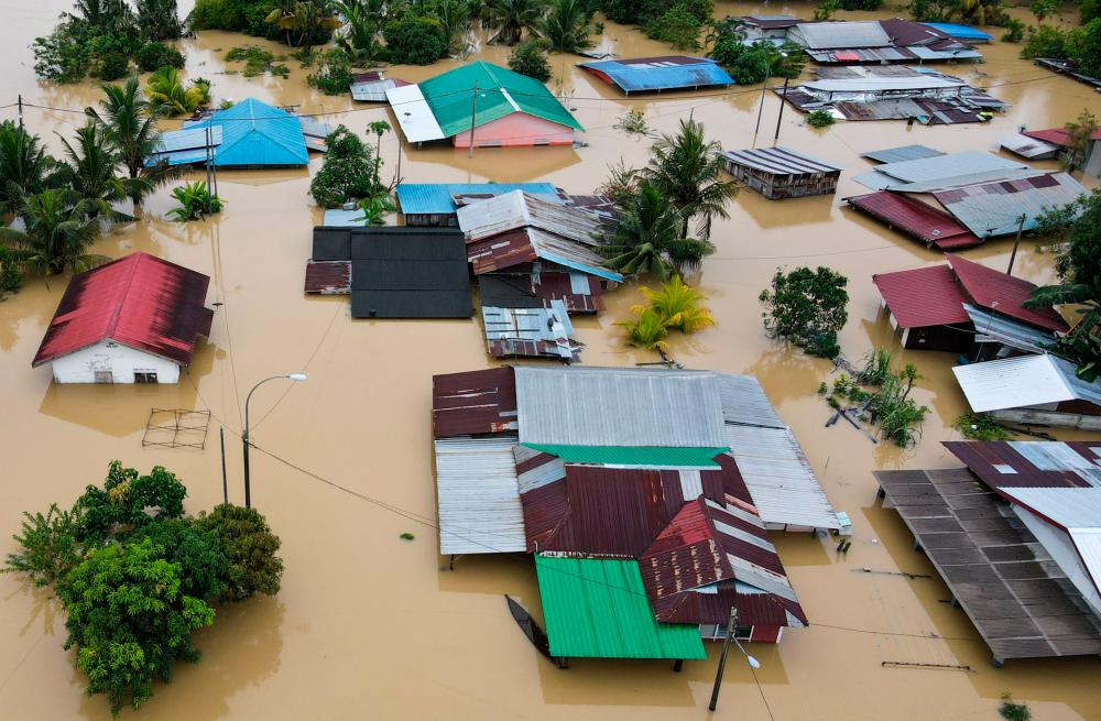 An aerial view shows flooded houses in Yong Peng, Malaysia’s Johor state, on March 4, 2023. BERNAMAPIX