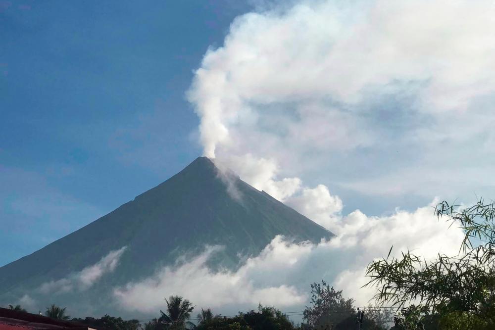 This handout photo made available by Kristin Moral shows the Mount Mayon spewing white smoke as seen from Camalig on June 8, 2023. AFPPIX