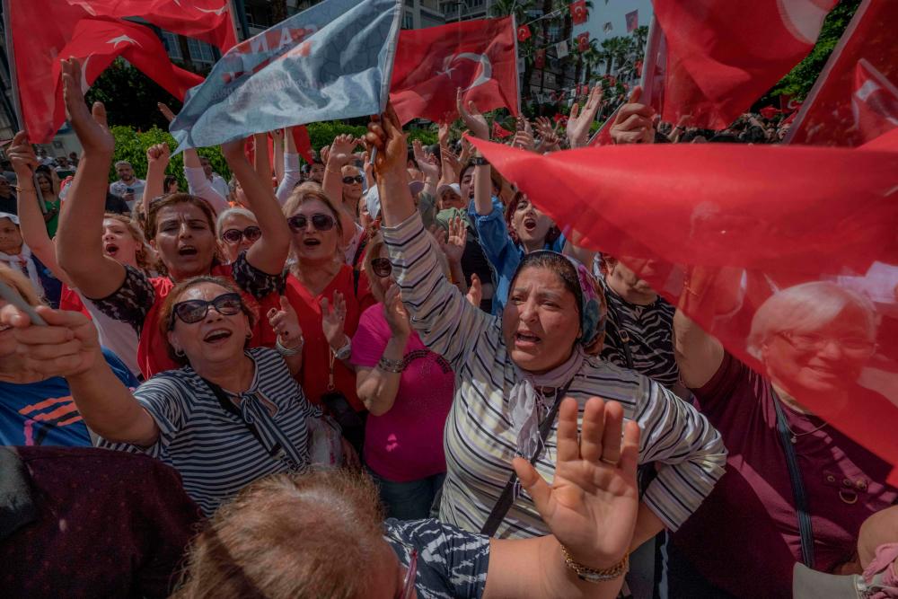 Supporters of Turkey’s Republican People’s Party (CHP) Chairman and Presidential candidate Kemal Kilicdaroglu wave during a campaign meeting at the municipality theatre in Adana, on May 25, 2023, ahead of the May 28 presidential runoff vote. AFPPIX