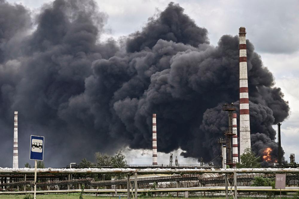 Smoke rises from an oil refinery after an attack outside the city of Lysychans’k in the eastern Ukranian region of Donbas, on May 22, 2022, on the 88th day of the Russian invasion of Ukraine. AFPPIX