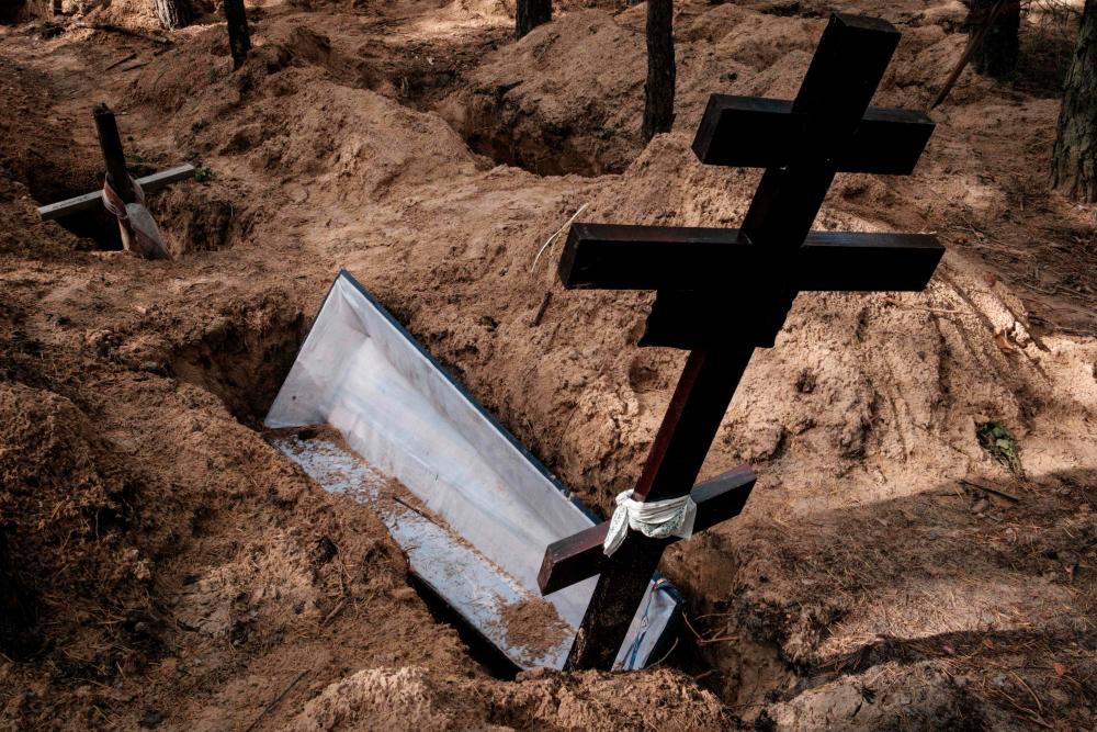 This photograph taken on September 25, 2022, shows empty graves after exhumation of bodies in the mass grave created during the Russian’s occupation in Izyum, Kharkiv region, amid the Russian invasion of Ukraine. AFPPIX