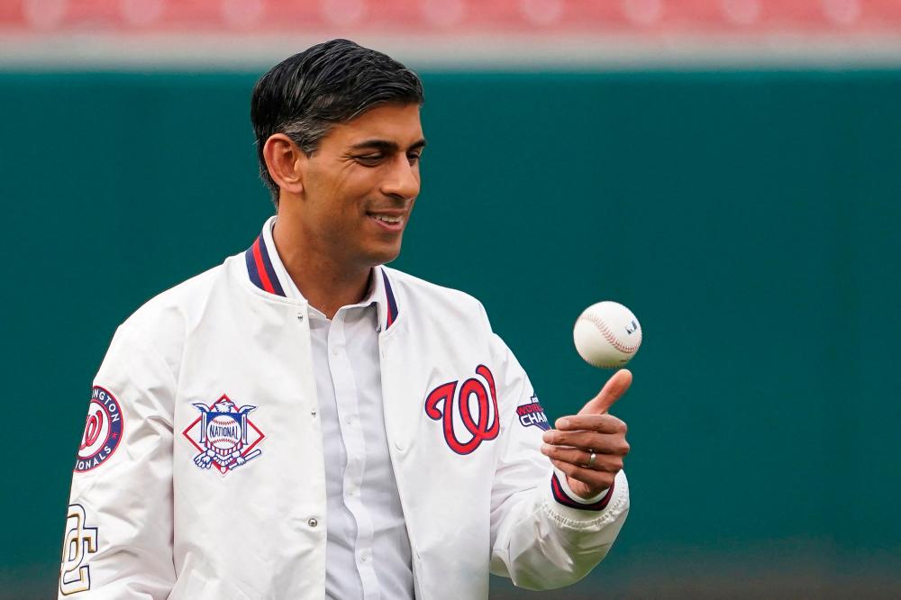 Britain’s Prime Minister Rishi Sunak holds a baseball prior to a Washington Nationals baseball game at Nationals Park in Washington, DC, on June 7, 2023. AFPPIX