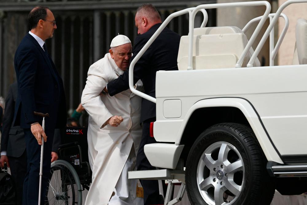 Pope Francis is helped get up the popemobile car as he leaves on March 29, 2023 at the end of the weekly general audience at St. Peter’s square in The Vatican. AFPPIX
