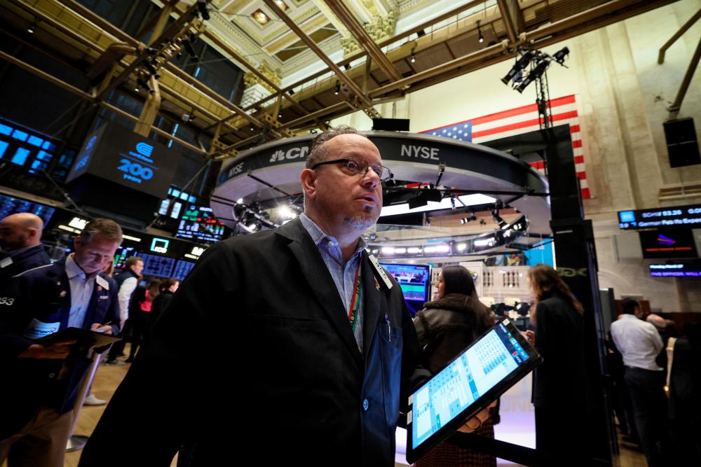 Traders working on the floor of the New York Stock Exchange on Monday, March 27, 2023. – Reuterspic