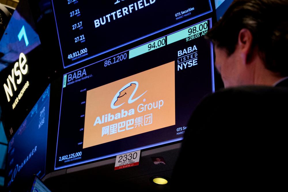 A trader working at the post where Alibaba is traded on the floor of the New York Stock Exchange ypday (March 28). – Reuterspic