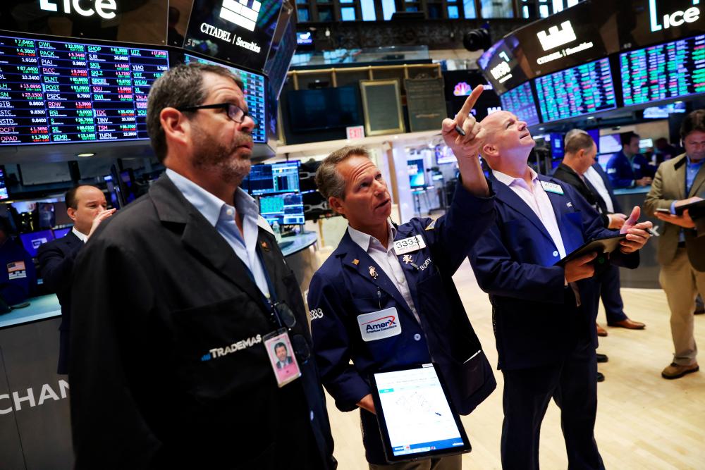 Traders at work on the New York Stock Exchange trading floor on Monday, Aug 8. – Reuters