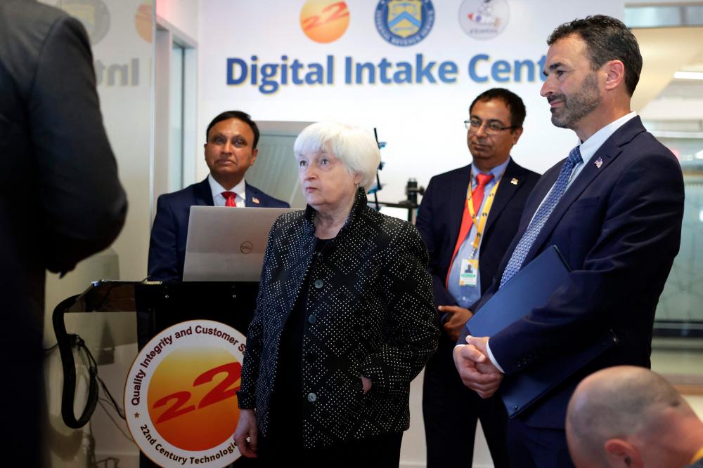 Yellen and IRS Commissioner Daniel Werfel (right) listen to a demonstration of the Digital Intake Initiative, a scanning technology for IRS paperless processing, during an event at 22nd Century Technologies on Wednesday, Aug 2, in McLean, Virginia. – AFPpic